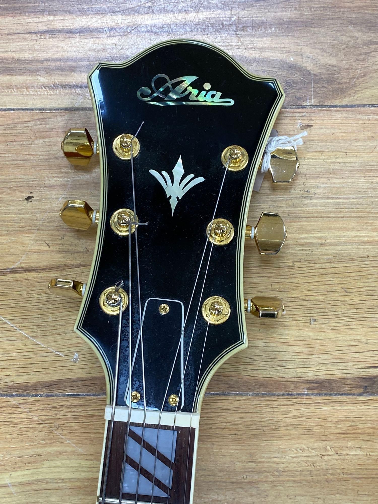 An Aria Career electric acoustic and jazz guitar, in soft case